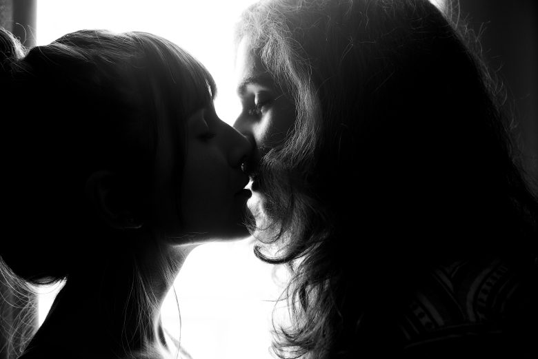 two women kissing and lap dance