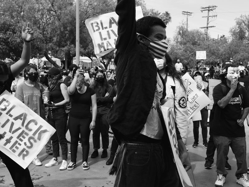 People protesting with Black Lives Matter signs and masks on