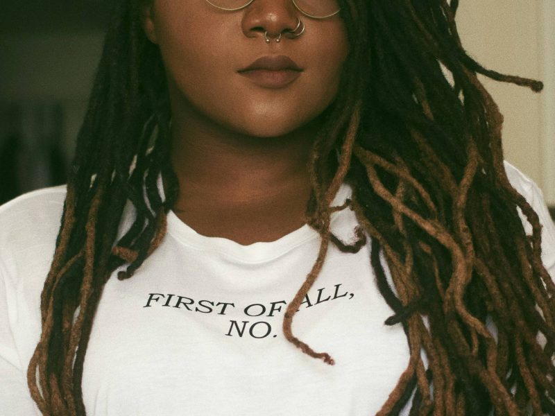 image of a Black woman wearing a shirt that says, first of all, no