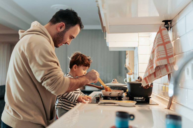 a-man-and-a-child-cooking-in-a-kitchen