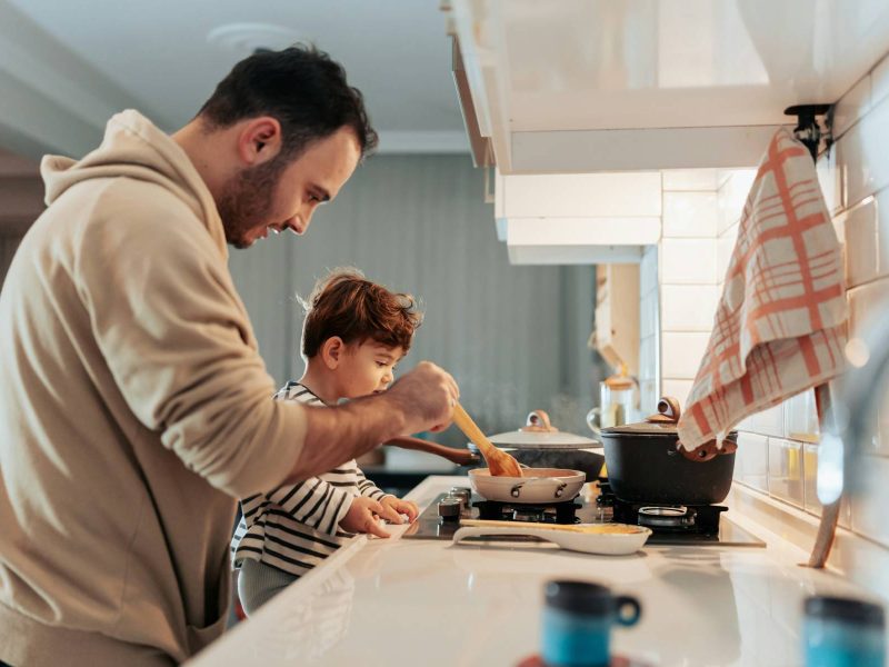 a-man-and-a-child-cooking-in-a-kitchen